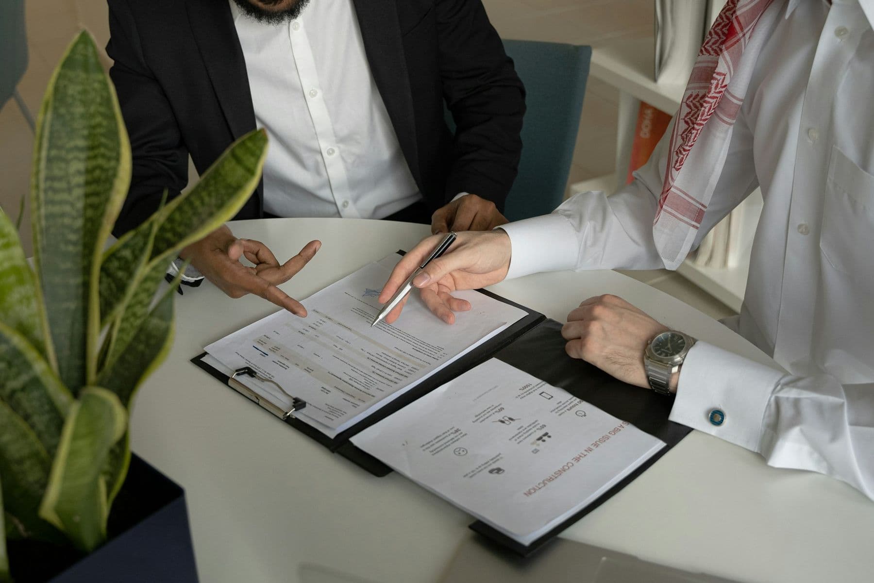 A client signing documents across the desk from their lawyer